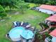 Aerial view of backyard featuring above ground pool with wooden deck, lush lawn, and a privacy fence at 274 Harvest Rd, Moncks Corner, SC 29461