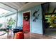 Exterior featuring a red door, wall decor and seating area with plants on an outdoor patio at 274 Harvest Rd, Moncks Corner, SC 29461