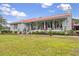 Charming single story home with a welcoming red metal roof, a covered front porch, and landscaped garden at 274 Harvest Rd, Moncks Corner, SC 29461