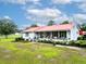 Charming single story home boasting a welcoming front porch and red metal roof, surrounded by a garden at 274 Harvest Rd, Moncks Corner, SC 29461