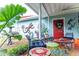 Outdoor patio featuring unique art, red door, water fountain and seating at 274 Harvest Rd, Moncks Corner, SC 29461