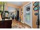 Inviting foyer boasts wood flooring, a decorative rug, and a glass-paneled front door at 274 Harvest Rd, Moncks Corner, SC 29461