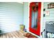 Bright red front door adorned with seasonal wreath welcomes you into this charming home at 274 Harvest Rd, Moncks Corner, SC 29461