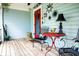 Cozy covered porch with seating, decor, and rustic charm offers a relaxing outdoor space at 274 Harvest Rd, Moncks Corner, SC 29461
