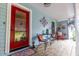 A charming front porch with cozy seating, decorative accents, and a glimpse of the inviting interior through the red door at 274 Harvest Rd, Moncks Corner, SC 29461