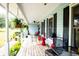 Inviting covered front porch with seating for relaxing and enjoying the outdoors at 274 Harvest Rd, Moncks Corner, SC 29461