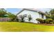 Well-maintained home featuring a manicured lawn and garden, with a red metal roof and light blue siding at 274 Harvest Rd, Moncks Corner, SC 29461