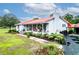 Well-maintained home with landscaped front yard, red roof, inviting porch, and a side driveway at 274 Harvest Rd, Moncks Corner, SC 29461