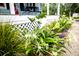 Lush greenery and blooming flowers decorate the front yard of this charming home at 274 Harvest Rd, Moncks Corner, SC 29461