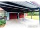 Shot of a covered two-car garage showing off ample space for vehicles and outdoor equipment at 274 Harvest Rd, Moncks Corner, SC 29461
