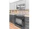 Modern kitchen featuring stainless steel appliances, granite countertops, and a stylish tile backsplash at 274 Harvest Rd, Moncks Corner, SC 29461
