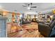 Open living room with hardwood floors, leather seating, ceiling fans, and colorful rugs at 274 Harvest Rd, Moncks Corner, SC 29461