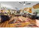 Spacious living room with wood flooring, leather furniture, and large windows at 274 Harvest Rd, Moncks Corner, SC 29461