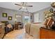 Neutral main bedroom with ceiling fan, makeup vanity, and a large window with natural light at 274 Harvest Rd, Moncks Corner, SC 29461