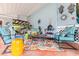 Cozy covered patio featuring comfortable seating, vibrant decor, and a colorful rug at 274 Harvest Rd, Moncks Corner, SC 29461