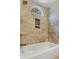 Modern bathroom featuring tile walls, a tub, and a decorative window at 339 Mount Royall Dr, Mount Pleasant, SC 29464