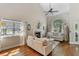 Bright living room featuring a fireplace, hardwood floors, and a large window at 339 Mount Royall Dr, Mount Pleasant, SC 29464