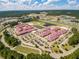 An aerial view of a large school complex with sports fields, parking lots, and surrounding greenery at 364 Deep River Rd, Summerville, SC 29486