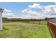 Sprawling backyard featuring lush green grass, a sturdy wooden fence, and mature trees at 364 Deep River Rd, Summerville, SC 29486