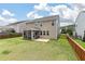 Side view of a two-story home featuring a well-manicured lawn and a screened in porch and brick patio at 364 Deep River Rd, Summerville, SC 29486