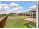 View of a fenced in backyard featuring a manicured lawn and view of the pond in the neighborhood at 364 Deep River Rd, Summerville, SC 29486