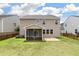 View of a two-story home featuring a well-manicured lawn and a screened in porch and brick patio at 364 Deep River Rd, Summerville, SC 29486