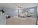 Serene bedroom with three windows, a ceiling fan, and carpet flooring at 364 Deep River Rd, Summerville, SC 29486