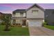 Charming two-story home featuring a well-manicured lawn, stone accents, and a two-car garage at 364 Deep River Rd, Summerville, SC 29486
