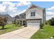 Two-story home with an attached two car garage and large driveway with lush lawn at 364 Deep River Rd, Summerville, SC 29486