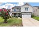 Beautiful two-story home with a well-maintained lawn, stone accents, and a two-car garage at 364 Deep River Rd, Summerville, SC 29486