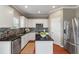 Well-lit kitchen features granite countertops, stainless steel appliances, and a mosaic backsplash at 364 Deep River Rd, Summerville, SC 29486