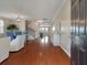 Open-concept living and dining room, wood floors, and lots of light from front door windows at 364 Deep River Rd, Summerville, SC 29486