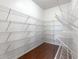 Walk-in pantry with wall-to-wall white wire shelving and hardwood floors at 364 Deep River Rd, Summerville, SC 29486