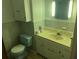 Full bathroom featuring a blue toilet and a yellow sink with vanity, plus patterned wallpaper at 379 Chestnut Rd, Walterboro, SC 29488