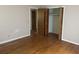 Bedroom features hardwood floors, light pink walls, a closet with folding doors, and an adjacent room at 379 Chestnut Rd, Walterboro, SC 29488