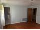 Bright bedroom with hardwood floors, pastel blue walls, and two doorways leading to other rooms at 379 Chestnut Rd, Walterboro, SC 29488