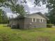 Brick house exterior showing a lush green lawn, AC unit and satellite dish at 379 Chestnut Rd, Walterboro, SC 29488