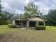 Charming brick home featuring a lattice trimmed covered front porch and a well-maintained lawn at 379 Chestnut Rd, Walterboro, SC 29488