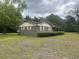View of brick house exterior showing lush green lawn and mature landscaping at 379 Chestnut Rd, Walterboro, SC 29488