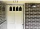 Front door of home with glass panels, adjacent to classic brick exterior at 379 Chestnut Rd, Walterboro, SC 29488