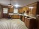Spacious kitchen with wood cabinets, laminate countertops, and black and white tile flooring at 379 Chestnut Rd, Walterboro, SC 29488