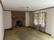 Living room featuring a brick fireplace, neutral walls, and vintage curtains at 379 Chestnut Rd, Walterboro, SC 29488
