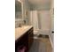Bright bathroom with vanity, granite countertop, shower with white curtain, and updated fixtures at 3808 Tupelo Branch Row, Mount Pleasant, SC 29429