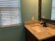 This bathroom has a granite countertop, mirror, and a bright window at 3808 Tupelo Branch Row, Mount Pleasant, SC 29429