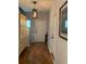 Inviting entryway with hardwood floors, neutral paint, stylish lighting, and decorative cabinet and artwork at 3808 Tupelo Branch Row, Mount Pleasant, SC 29429
