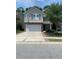 Charming two-story home with a stone-accented facade, attached two-car garage, and well-maintained front yard at 3808 Tupelo Branch Row, Mount Pleasant, SC 29429
