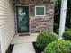 Charming front entrance with stone veneer, glass door, decorative plants, and visible house number at 3808 Tupelo Branch Row, Mount Pleasant, SC 29429