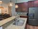 Modern kitchen with granite countertops, stainless steel appliances, and rich wood cabinetry at 3808 Tupelo Branch Row, Mount Pleasant, SC 29429