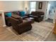 Comfortable living room with leather furniture, stylish rug, hardwood floors and natural light from the nearby window at 3808 Tupelo Branch Row, Mount Pleasant, SC 29429