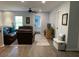 Inviting living room featuring hardwood floors, leather sofas, a ceiling fan, and an open doorway to an airy bedroom at 3808 Tupelo Branch Row, Mount Pleasant, SC 29429